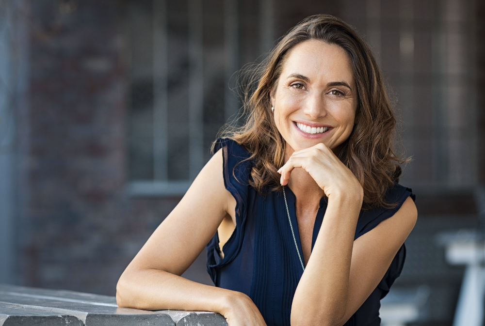A smiling woman after comprehensive dentistry in Aston PA