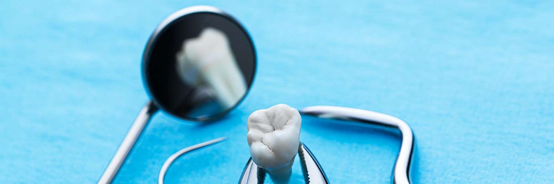 A dental mirror and a tooth model in Aston, PA