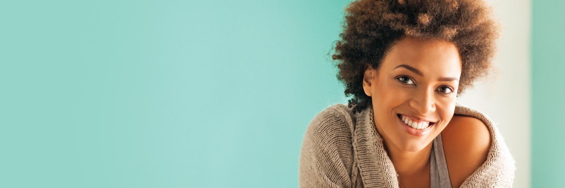 Patient smiling after cosmetic dentistry in Aston PA