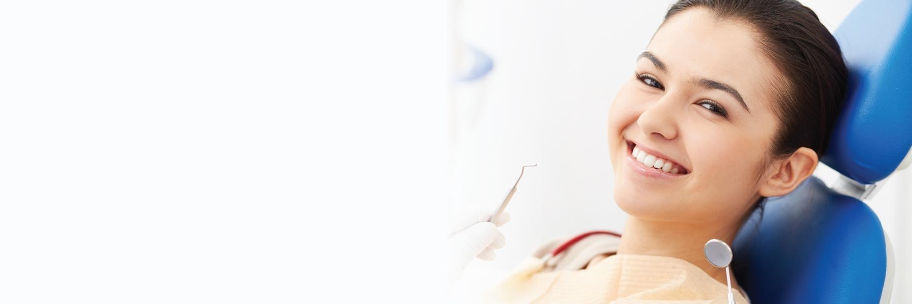 Woman smiling in treatment chair at dentist in Aston PA